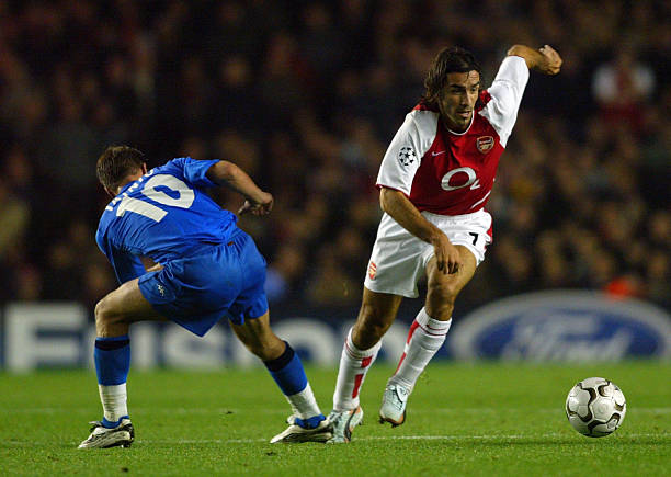 Robert Pires of Arsenal gets past Teemu Tainio of Auxerre during the Champions League First Phase Group A match between Arsenal and AJ Auxerre at...