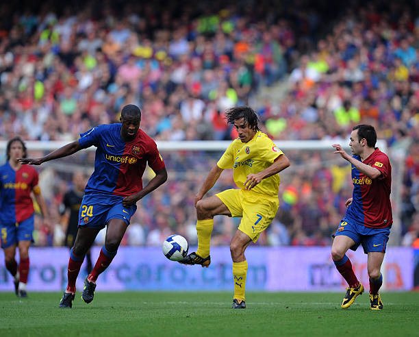 Robert Pires of Villarreal controls the ball while Toure Yaya and Andres Iniesta of Barcelona close in during the La Liga match between Barcelona and...