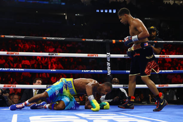 Robson Conceição falls to the canvas against Shakur Stevenson during their WBC/WBO Jr. Lightweight World title bout at Prudential Center on September...