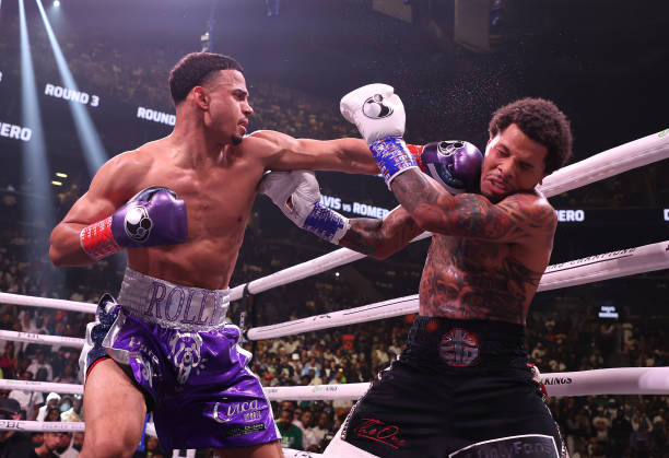 Rolando Romero punches Gervonta Davis during their fight for Davis' WBA World lightweight title at Barclays Center on May 28, 2022 in Brooklyn, New...