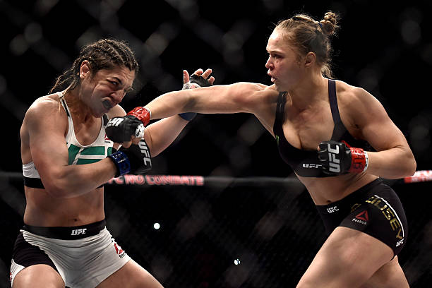 Ronda Rousey of the United States punches Bethe Correia of Brazil in their bantamweight title fight during the UFC 190 Rousey v Correia at HSBC Arena...