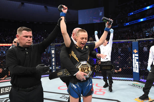 Rose Namajunas reacts after defeating Zhang Weili of China in their UFC women's strawweight championship bout as UFC President Dana White places the...