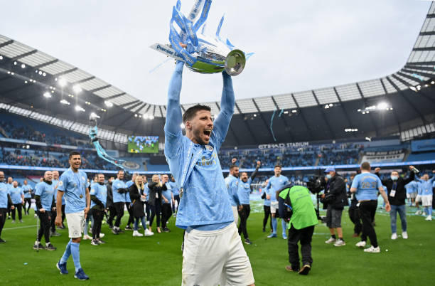 Ruben Dias of Manchester City celebrates with the Premier League Trophy as Manchester City are presented with the Trophy as they win the league...