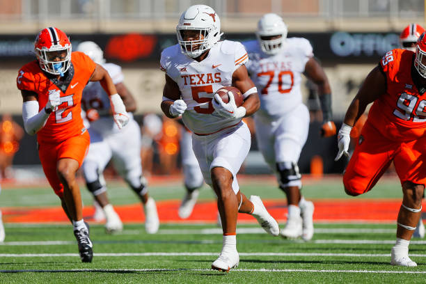 Running back Bijan Robinson of the Texas Longhorns finds an opening to run for a 42-yard touchdown against the Oklahoma State Cowboys in the first...