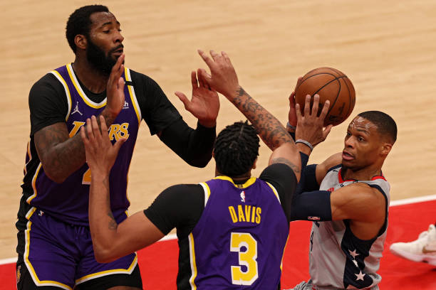 Russell Westbrook of the Washington Wizards looks to shoot in front of Andre Drummond and Anthony Davis of the Los Angeles Lakers during the first...