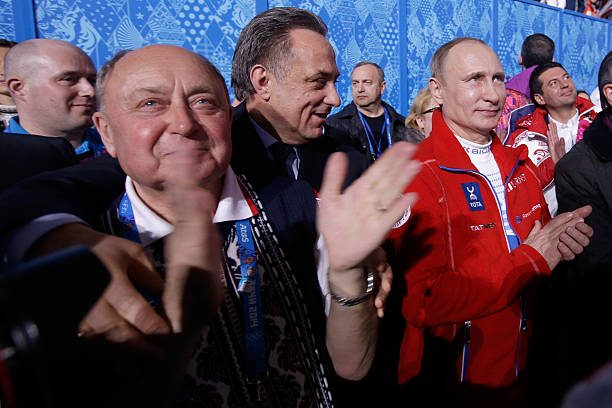 Russian Minister of Sport, Tourism and Youth policy Vitaly Mutko and Russian President Vladimir Putin walk through the arena after the Flower...