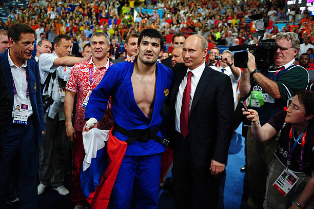Russian President Vladimir Putin celebrates Tagir Khaibulaev of Russia's gold medal in the Men's -100 kg Judo on Day 6 of the London 2012 Olympic...