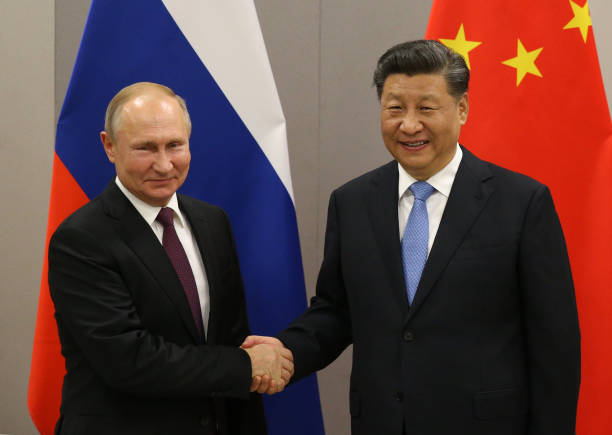 Russian President Vladimir Putin greets Chinese President Xi Jinping during their bilateral meeting on November 13, 2019 in Brasilia, Brazil. The...