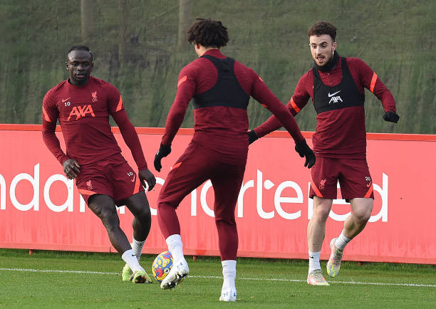 Sadio Mane of Liverpool with Diogo Jota of Liverpool during a training session at AXA Training Centre on December 24, 2021 in Kirkby, England.