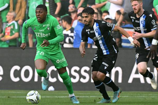 Saint-Etienne's French midfielder Zaydou Youssouf runs with the ball next to Auxerre's Moroccan midfielder Hamza Sakhi during the French L1-L2...