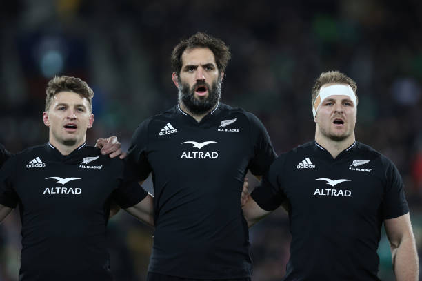 WELLINGTON, NEW ZEALAND - JULY 16: Sam Cane, captain of the All Blacks (R) with Sam Whitelock (C) and Beauden Barrett sing the national anthem during the International Test match between the New Zealand All Blacks and Ireland at Sky Stadium on July 16, 2022 in Wellington, New Zealand. (Photo by Phil Walter/Getty Images)