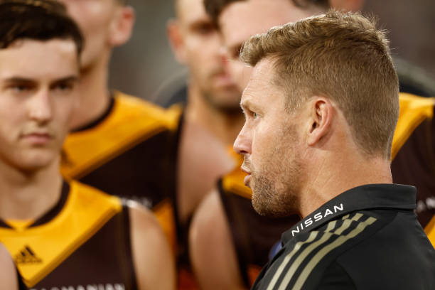 Sam Mitchell, coach of the Hawks speaks to his players during the round seven AFL match between the Melbourne Demons and the Hawthorn Hawks at...