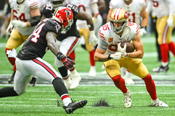 San Francisco tight end George Kittle prepares to take a hit from Atlanta linebacker Rashaan Evans during the NFL game between the San Francisco...