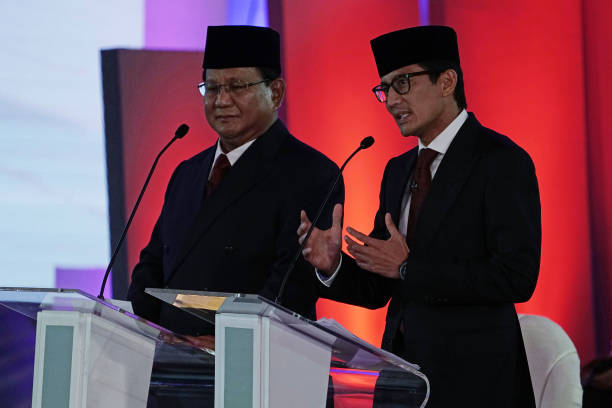 Sandiaga Uno vice presidential candidate right speaks while Prabowo Subianto presidential candidate listens during a first presidential debate in...