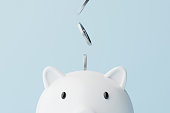 Save money and investment concept. Closeup piggy bank and silver coins falling. 3d rendering illustration
