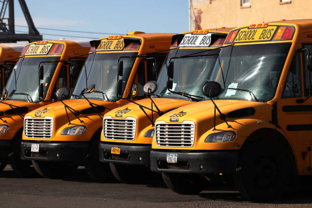 School buses are parked at a bus depot in the Red Hook neighborhood of Brooklyn on November 19, 2020 in New York City.  Mayor Bill de Blasio closed ...