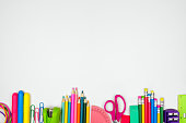 School supplies bottom border, top view on a white background with copy space. Back to school.