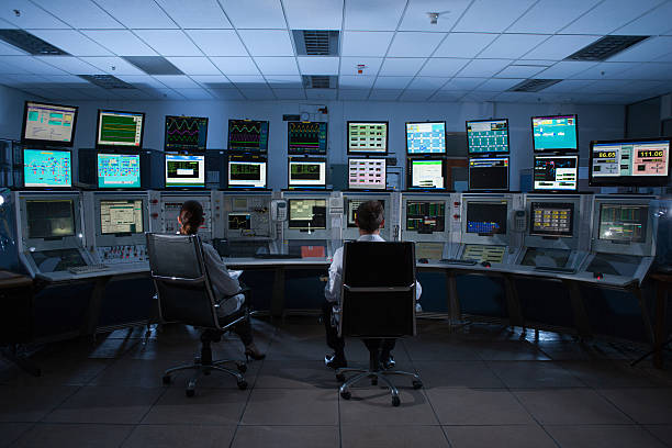 Scientists monitoring computers in control room