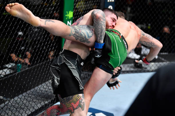 Sean Brady takes down Michael Chiesa in a welterweight fight during the UFC Fight Night event at UFC APEX on November 20, 2021 in Las Vegas, Nevada.