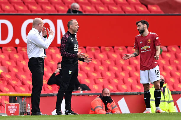 Sean Dyche, Manager of Burnley and coach Ian Woan talk to Bruno Fernandes of Manchester United during the Premier League match between Manchester...