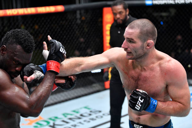 Sean Strickland punches Uriah Hall of Jamaica in a middleweight fight during the UFC Fight Night event at UFC APEX on July 31, 2021 in Las Vegas,...