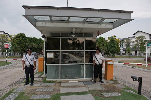 Security guards stand in front of the main gate house of 