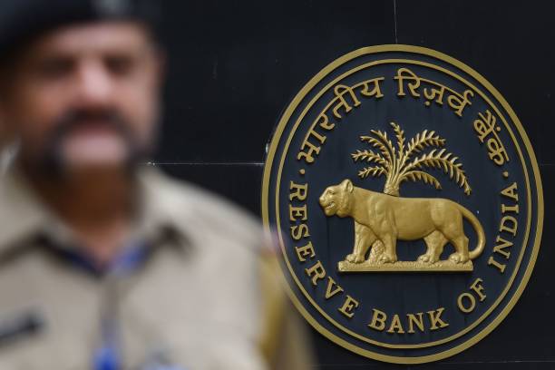 security staff walks past the logo of reserve bank of india at the rbi headquarters in mumbai on august 7, 2019. - india's central bank on august 7...