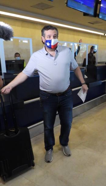 Sen. Ted Cruz checks in for a flight at Cancun International Airport after a backlash over his Mexican family vacation as his home state of Texas...