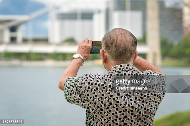 senior man using smartphone to take
