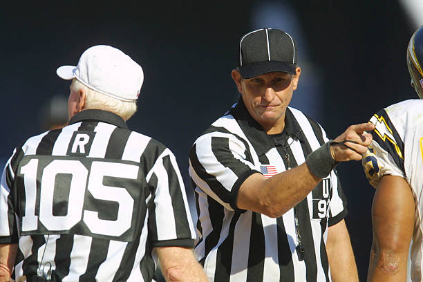 Referee Don Hanzak and umpire Carl Madsen discuss a call in the game between the San Diego Chargers and the Cincinnati Bengals at Qualcomm Stadium in...
