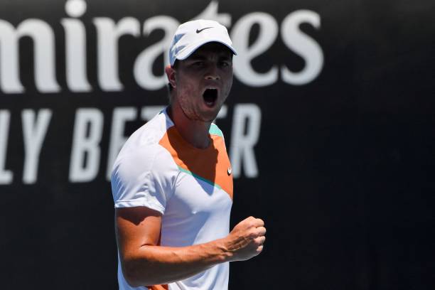 Serbia's Miomir Kecmanovic reacts after winning a set against Italy's Lorenzo Sonego during their men's singles match on day five of the Australian...