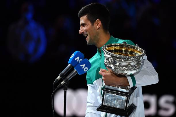 Serbia's Novak Djokovic holds the Norman Brookes Challenge Cup trophy after beating Russia's Daniil Medvedev to win their men's singles final match...