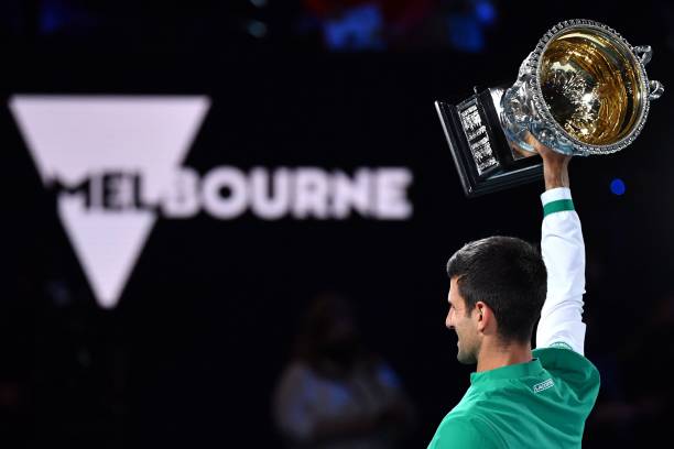 Serbia's Novak Djokovic holds the Norman Brookes Challenge Cup trophy after beating Russia's Daniil Medvedev to win their men's singles final match...