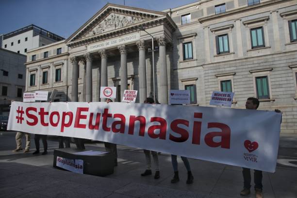 Several people from the 'Right to Live' organization are gathering in front of the Congress of Deputies with a banner that reads, 'Stop Euthanasia'...