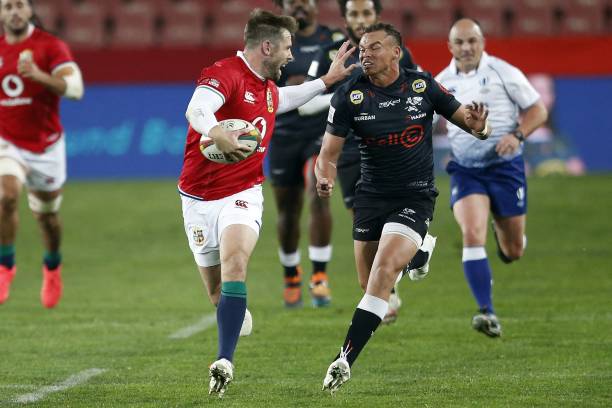 Sharks' fly-half Curwin Bosch (R) chases British and Irish Lions' centre Elliot Daly (L) during a rugby union tour match between the Sharks against the British and Irish Lions at the Ellis Park stadium in Johannesburg on July 7, 2021. (Photo by Phill Magakoe / AFP) (Photo by PHILL MAGAKOE/AFP via Getty Images)