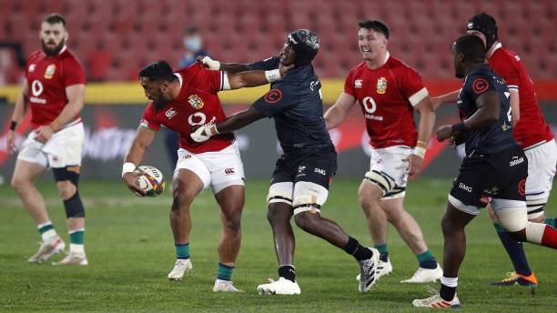 Sharks' loose forward Thembelani Bholi (L) tackles British and Irish Lions' centre Bundee Aki (R) during a rugby union tour match between the Sharks against the British and Irish Lions at the Ellis Park stadium in Johannesburg on July 7, 2021. (Photo by Phill Magakoe / AFP) (Photo by PHILL MAGAKOE/AFP via Getty Images)