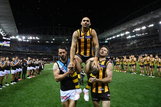 Shaun Burgoyne of the Hawks is chaired off by Travis Boak of the Power and Liam Shiels of the Hawks in his 400th game on July 03, 2021 in Melbourne,...