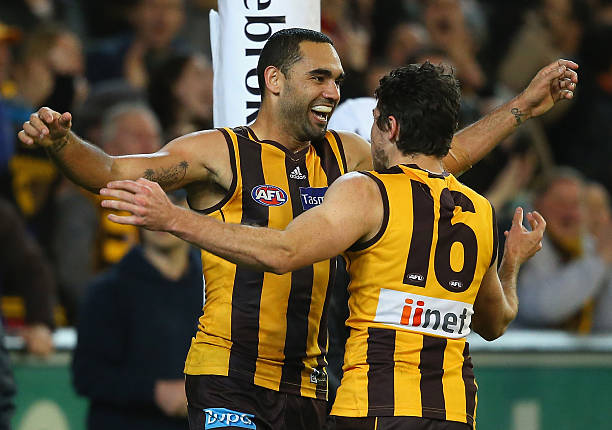 Shaun Burgoyne of the Hawks is congratulated by Cyril Rioli after kicking a goal during the AFL First Preliminary Final match between the Hawthorn...
