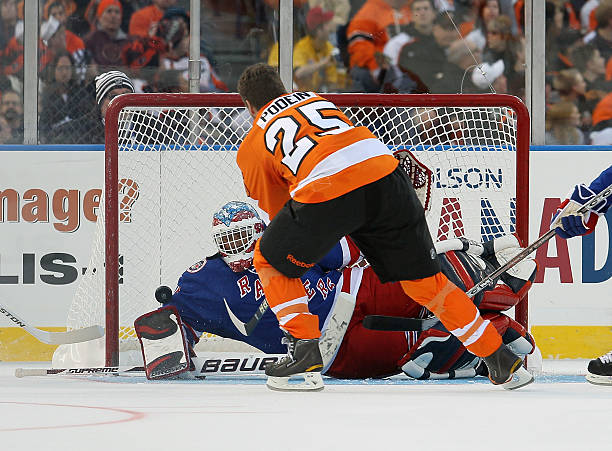 Shjon Podein of the Philadelphia Flyers scores a first period goal past John Vanbiesbrouck of the New York Rangers during the 2012 Bridgestone NHL...