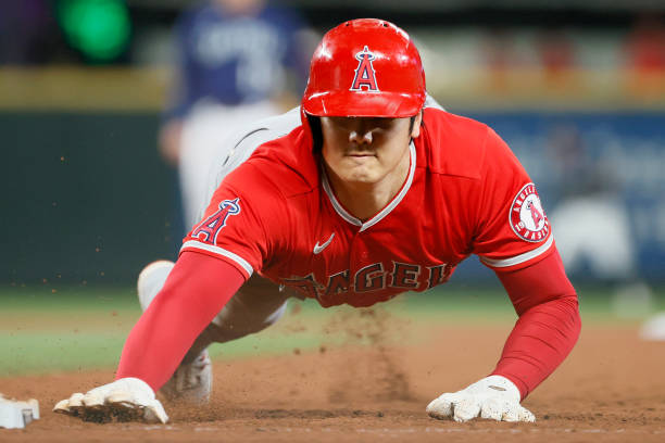 Shohei Ohtani of the Los Angeles Angels dives back to first base during the sixth inning against the Seattle Mariners at T-Mobile Park on October 02,...