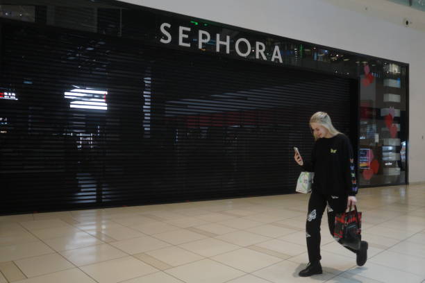 shopper walks in front of closed sephora cosmetics store in russia picture