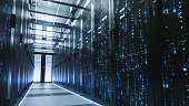 Shot of Corridor in Working Data Center Full of Rack Servers and Supercomputers with Blue Neon Visualization Projection of Data Transmission Processing with Digits, Hieroglyphs, other Code Characters