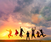 Silhouette Happy family people group celebrate jump for good life on weekend concept for win victory, person faith in financial freedom healthy wellness, Great insurance team support retreat together in summer.