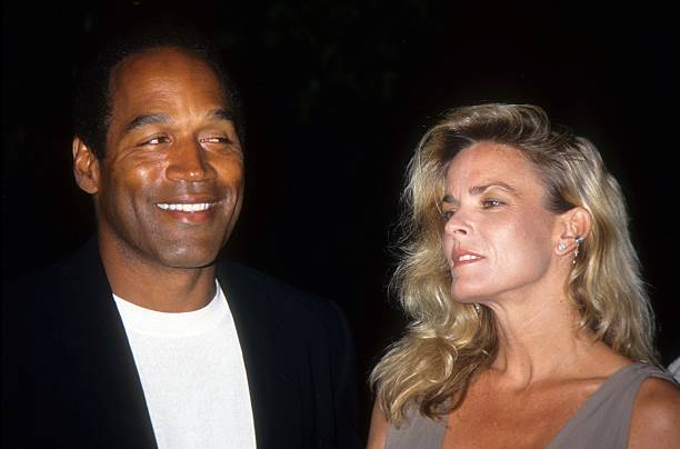 Simpson and Nicole Brown Simpson pose at the premiere of the "Naked Gun 33 1/3: The Final Isult" in which O.J. Starred on March 16, 1994 in Los...