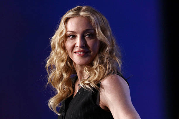 Singer Madonna looks on on during a press conference for the Bridgestone Super Bowl XLVI halftime show at the Super Bowl XLVI Media Center in the...