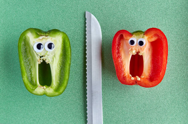 Sliced Pepper with sticky eyes screaming with knife