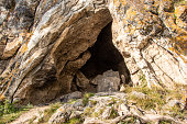 small cave or grotto in mountain cliff, mountaineering and caving in rocks