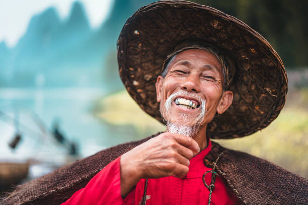 smiling chinese fisherman - asian old fisherman stock pictures, royalty-free photos & images