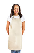 Smiling young african woman in apron