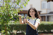 smiling young woman gardener with curly